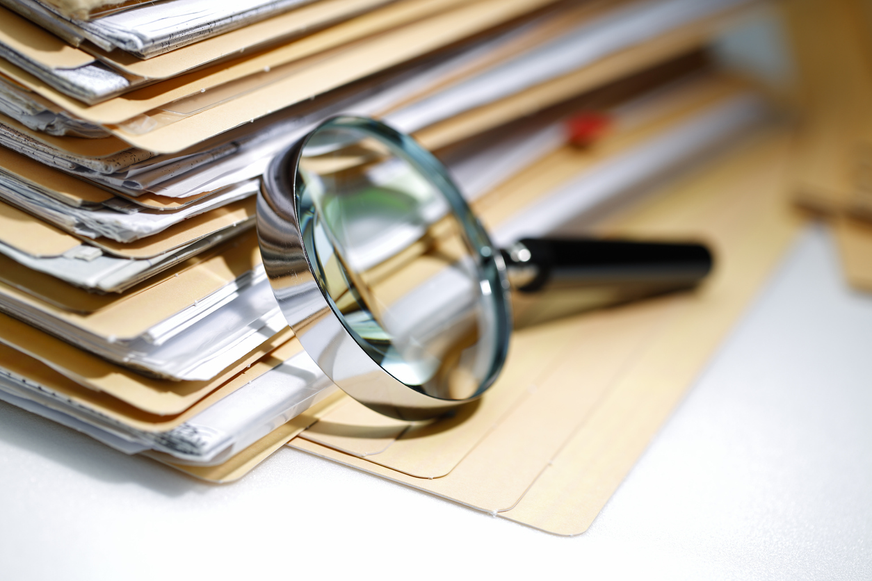 Magnifying glass Search Documents ; shot with very shallow depth of field
